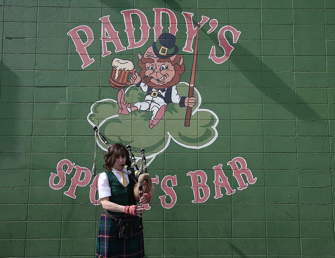 Kristin Stafford practices on the bagpipes outside Paddy's Sports Bar on St. Patrick's Day.