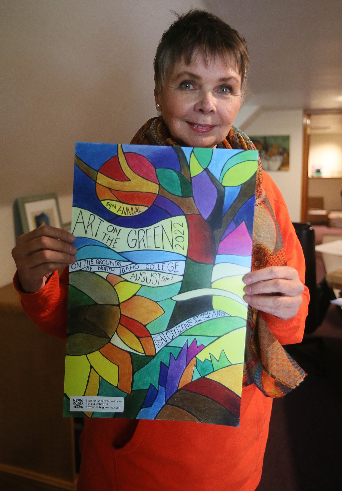 Cyndie Hammond won the 2022 Art on the Green Poster Contest. She is seen with her winning creation in May.