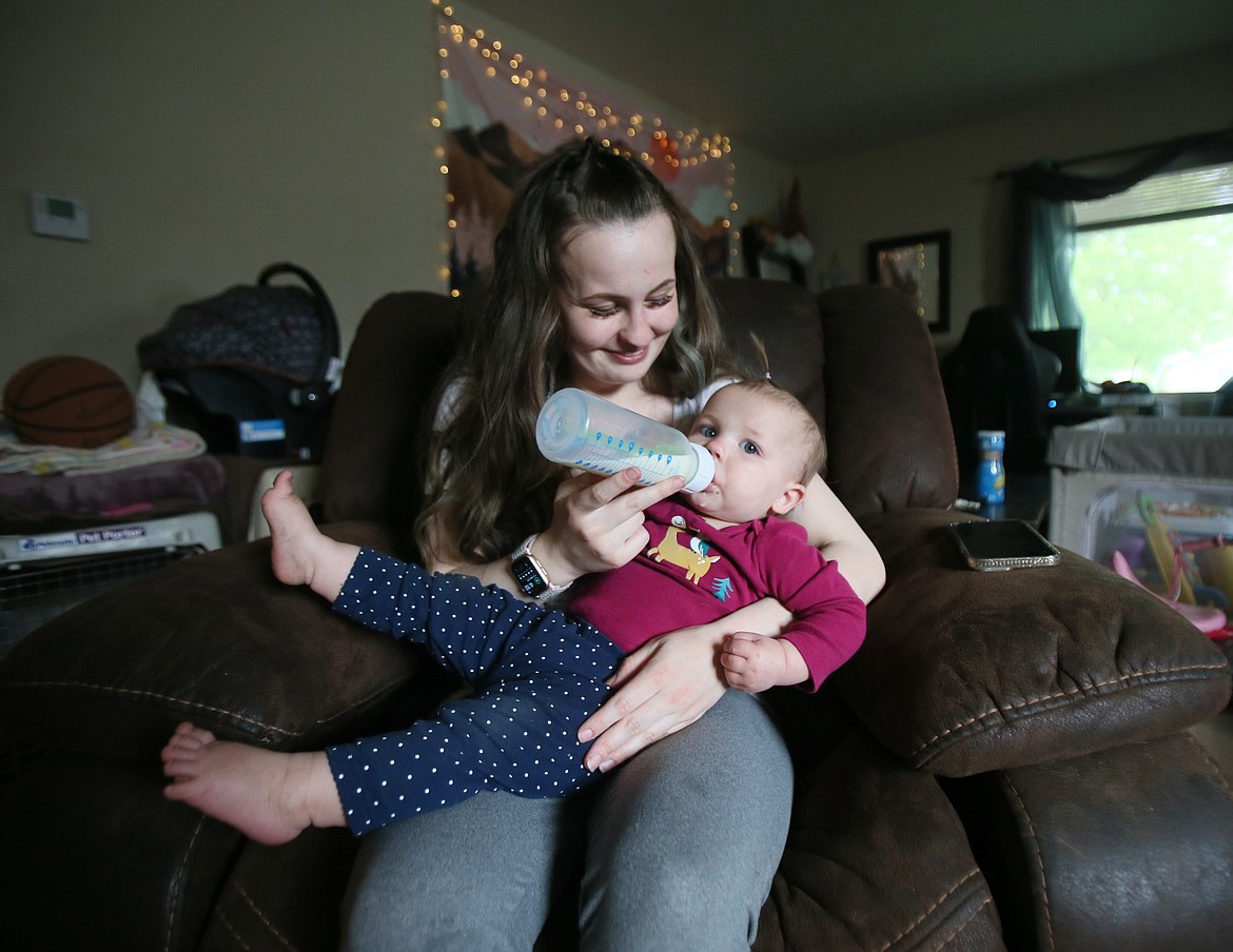 Brook Blankenship, 21, feeds her 11-month-old daughter Harlynn a bottle May 19 in their downtown Coeur d'Alene home. With baby No. 2 on the way, Blankenship felt the pinch of the national and local infant formula shortage.