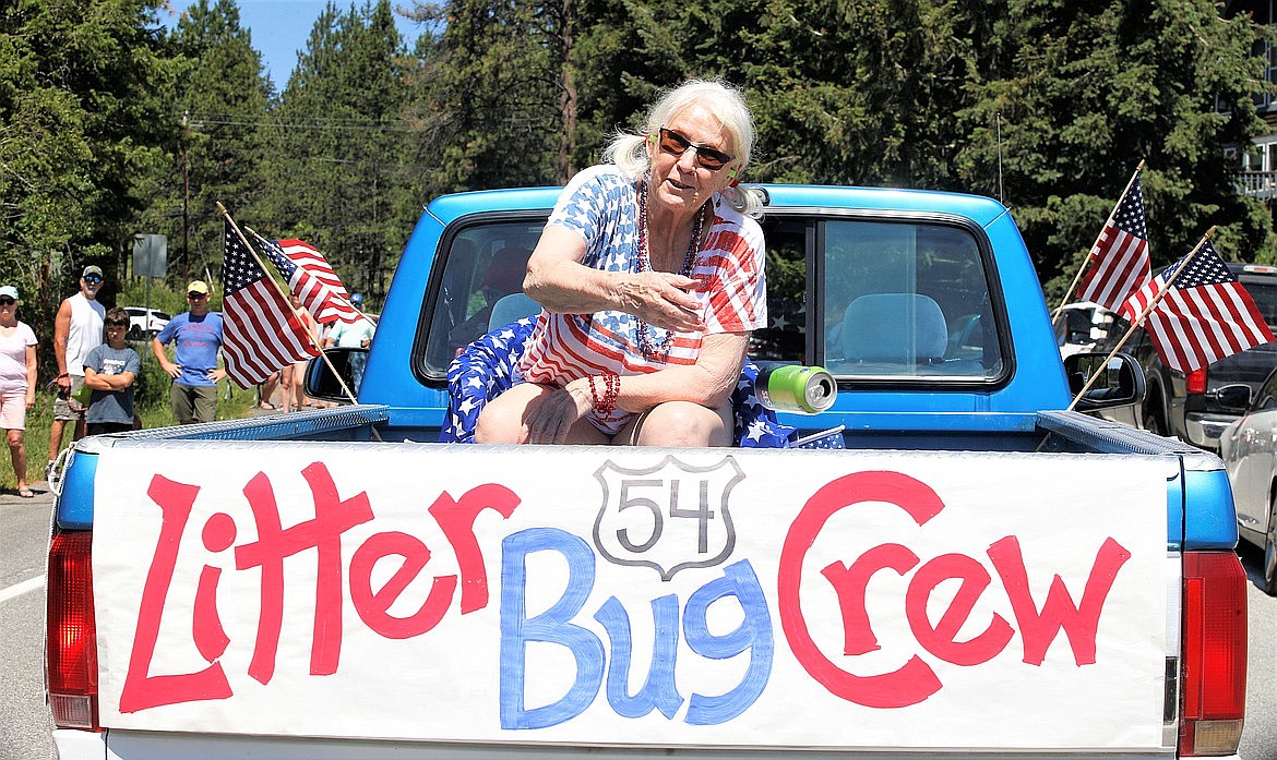 Margaret Nelson tosses out a can in her role with the Littler Bug Crew in the Bayview Daze Parade.