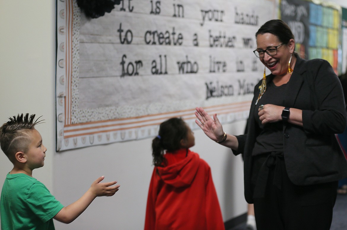 Hollie Mackey, executive director of the White House Initiative on Advancing Educational Equity, Excellence and Economic Opportunity for Native Americans and Strengthening Tribal Colleges and Universities, shares happy exchanges with first-graders during a June 3 site visit to the Coeur d'Alene Tribal School in De Smet.