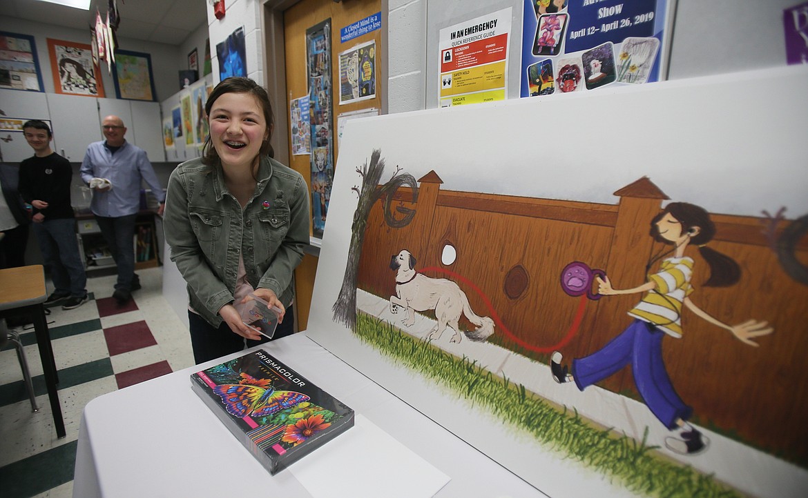 Post Falls High School freshman Kaylin "Kyle" O'Halloran beams a bright smile in May as she stands with her winning art for the Doodle for Google Student Contest. Her brother, Keagan, and dad, Pat, are pictured in the background.