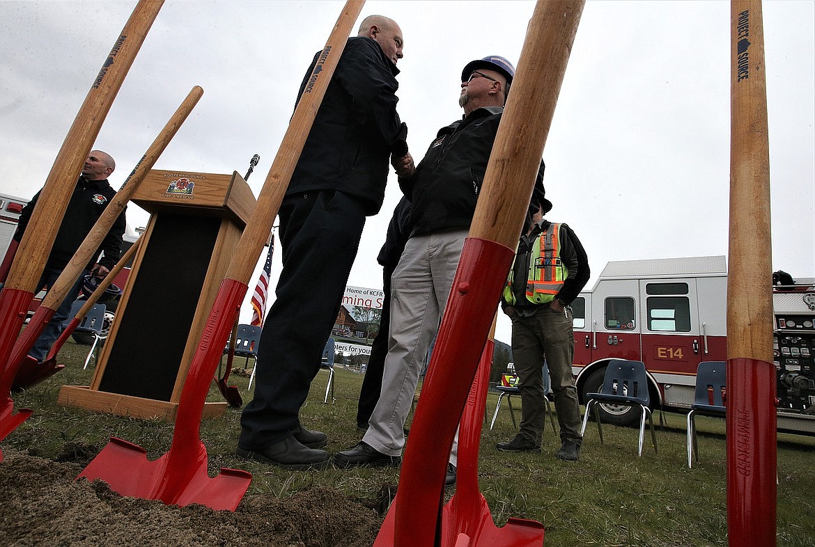 Kootenai County Fire & Rescue Fire Chief Chris Way, left, shakes hands with KCRF Commissioner Michael Hunt following Thursday's groundbreaking for the new fire station at the Kootenai County Fairgrounds in April.