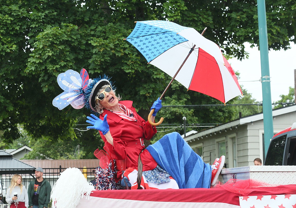 American Heroes Parade Grand Marshal Mikki Stevens strikes a pose as she rolls along the parade route on the Fourth of July.