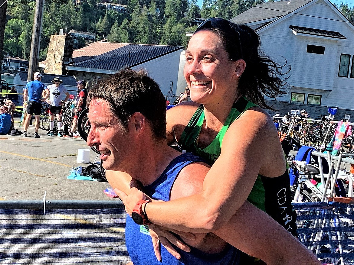 Megan Leary enjoys a piggyback ride from husband Shaun Leary to finish line of the Hayden Triathlon in July.