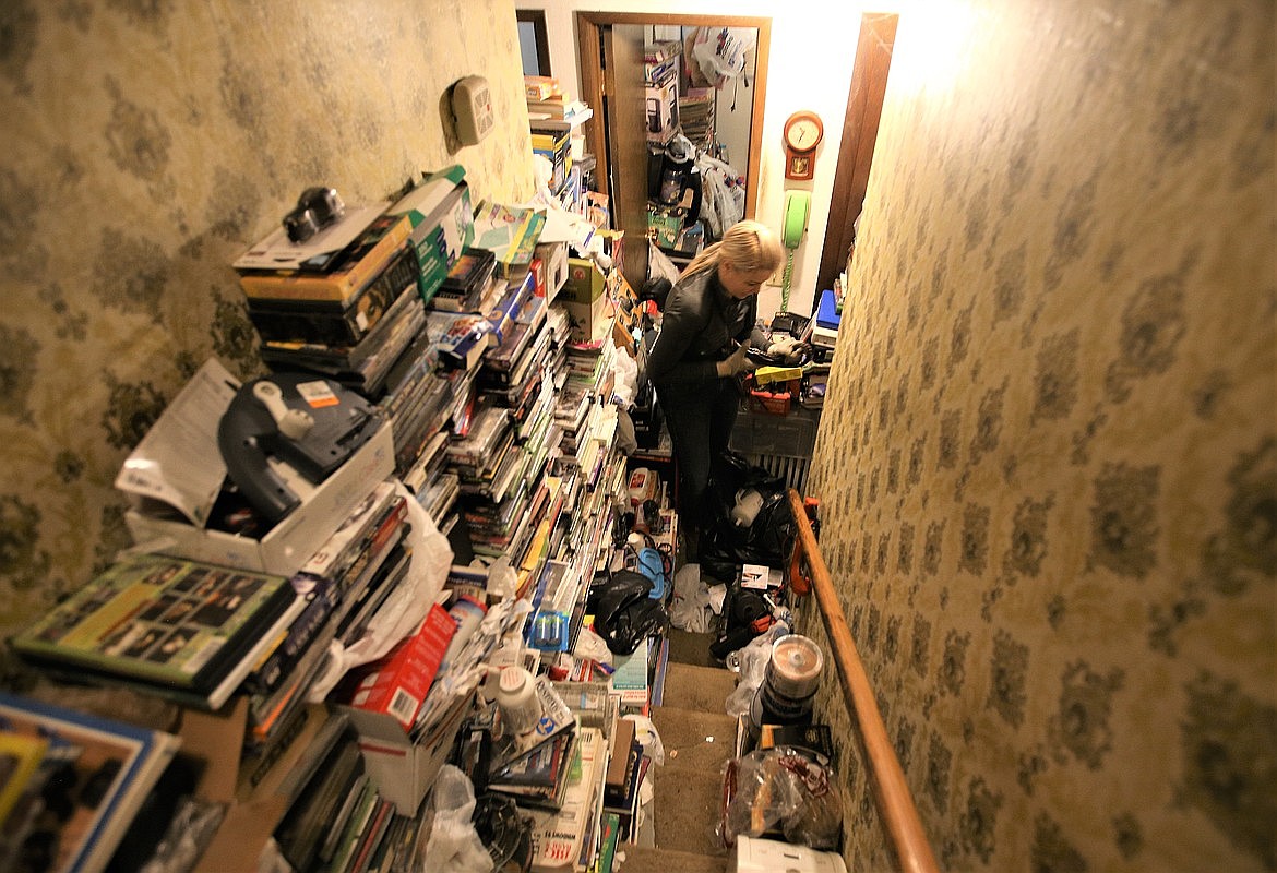 Gina Zawis, with Quality Estate Sale, cleans out a hoarder's home in Coeur d'Alene in April.