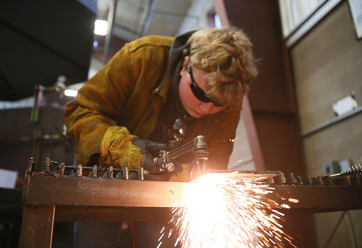 Coeur d'Alene High School junior Erik Wise cuts through a piece of metal at Kootenai Technical Education Campus (KTEC) during class Sept. 30. KTEC's welding and automotive technology instructors received more than $300,000 in grants to expand and better equip the programs.