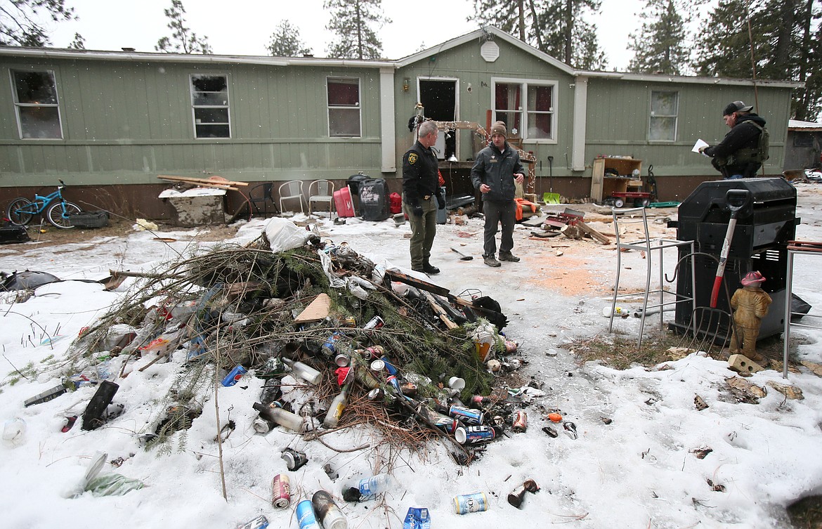 Kootenai County Sheriff Bob Norris and Panhandle Health District environmental health specialist Jason Peppin on Feb. 2 discuss health violations on a Coeur d'Alene property where a man was taken into custody for aggravated assault and unlawful possession of a firearm.