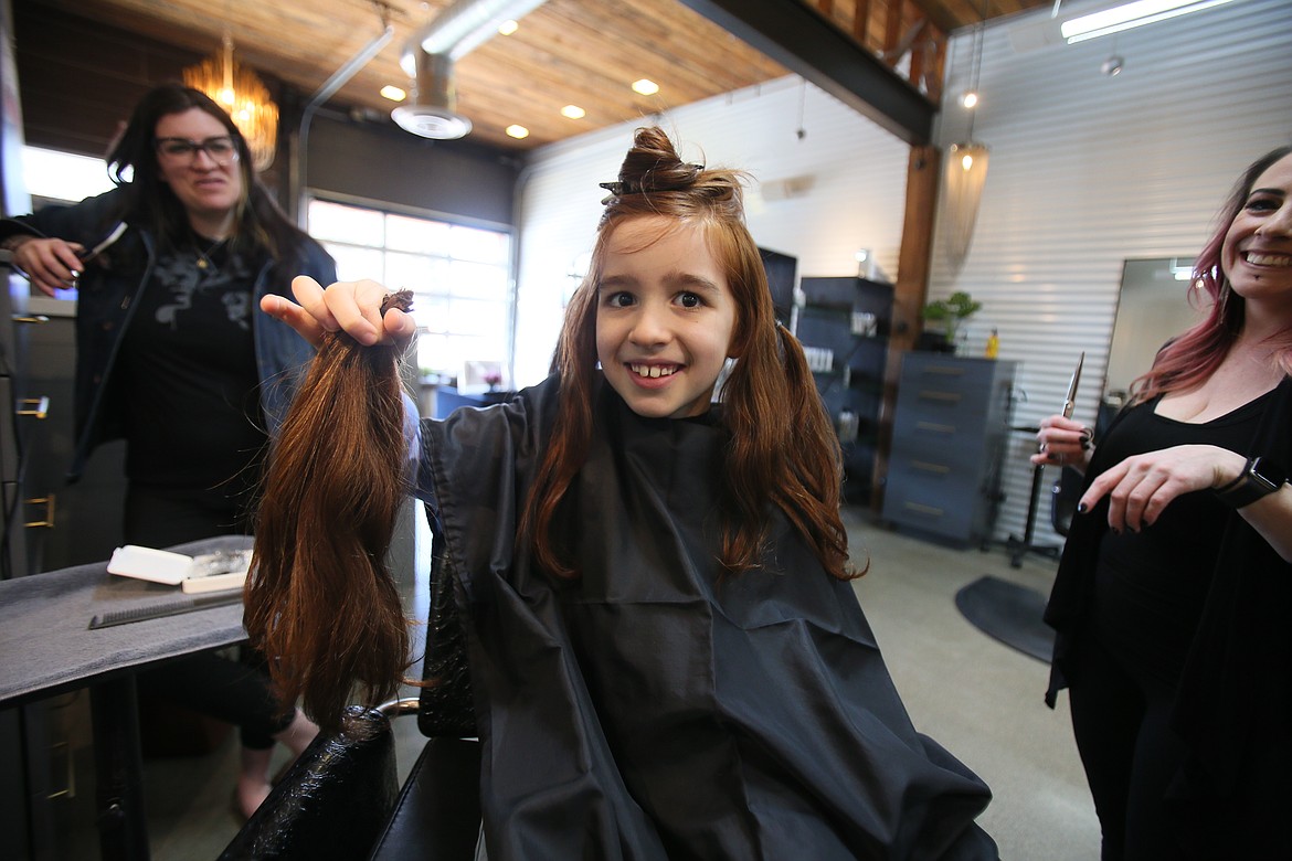 Ricky Schuerger, 8, on Feb. 18 holds up some of his glorious red hair that he donated to Hair We Share, a nonprofit that makes wigs for people experiencing medical hair loss.