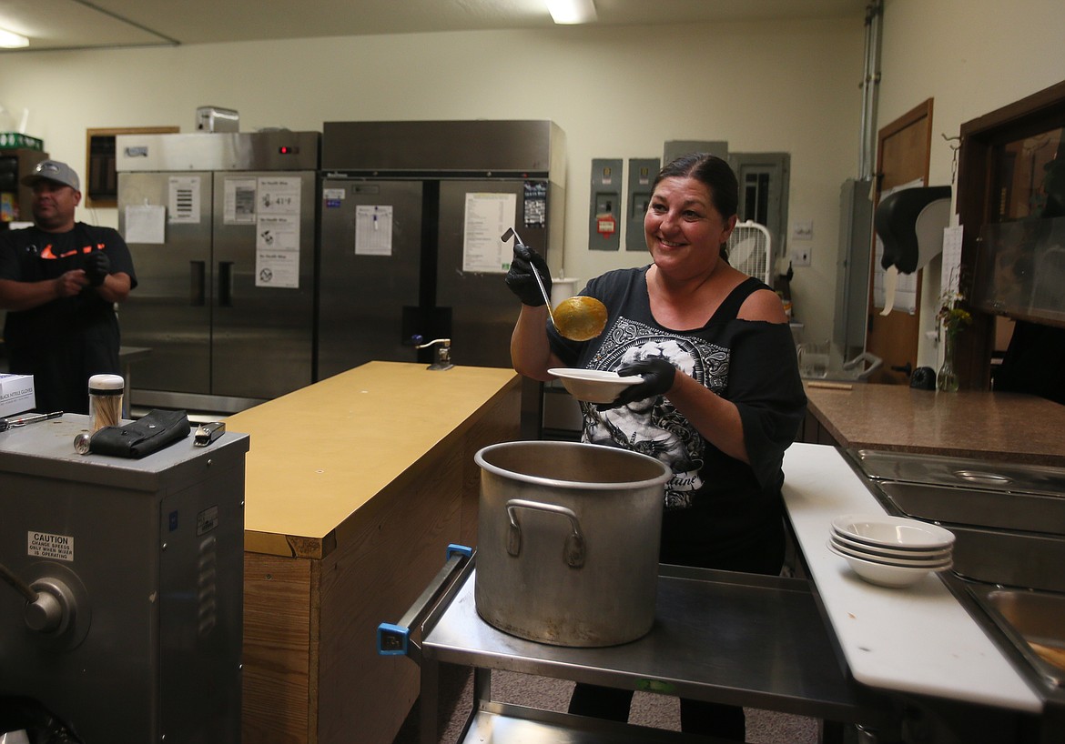 Assistant chef Johanna Byers serves up tomato soup Aug. 3 at the Post Falls Senior Center.