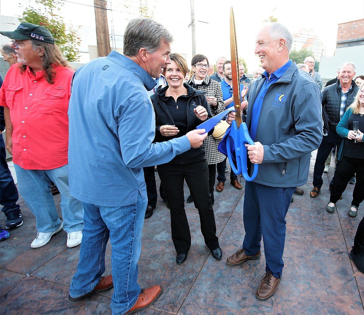 Coeur d'Alene Rotary Centennial Park project co-chairs Bob Burton, right, and Jody Azevedo chat with John Young, design committee chairman, during the park's grand opening on Sherman Avenue in October.