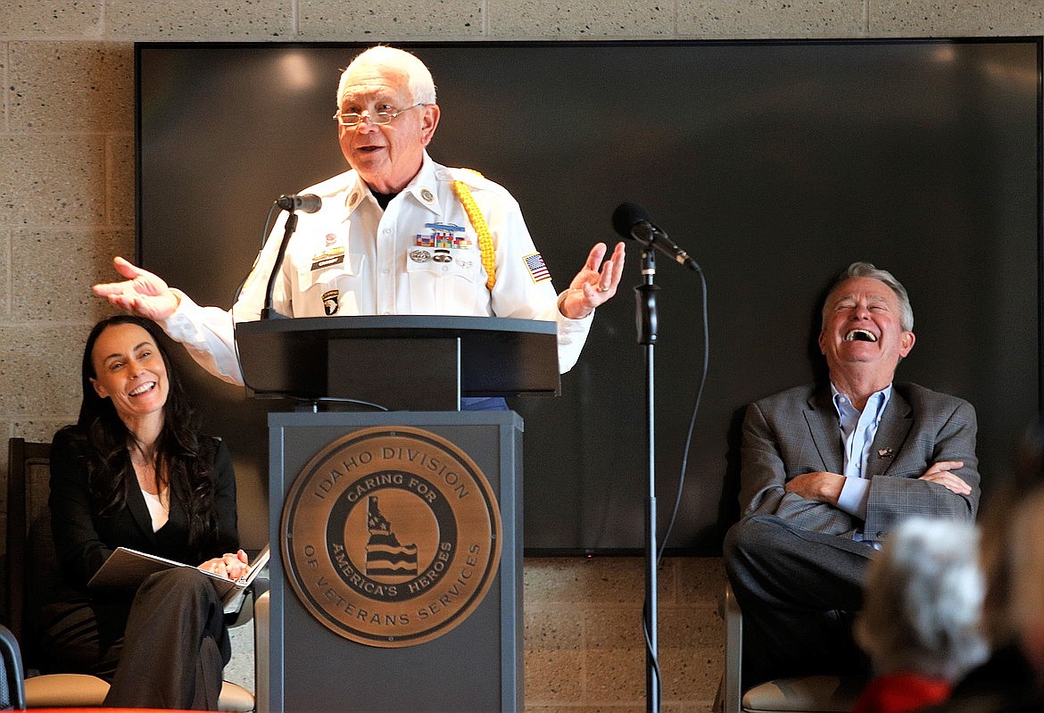 Len Crosby shares a humorous comment during his keynote speech at the dedication of the Veterans Home in Post Falls in Novembe while Gov. Brad Little and Division of Veterans Services Deputy Chief Tracy Schaner laugh.