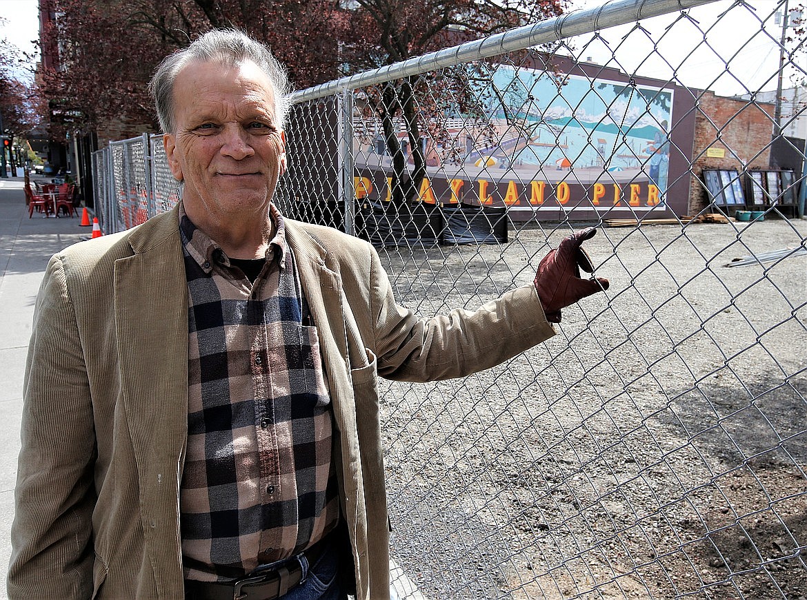 Chris Guggemos, known as "The Music Man," stands in front of Sherman Square Park in early 2022. Guggemos died in September after a six-year battle with cancer. He was 68.