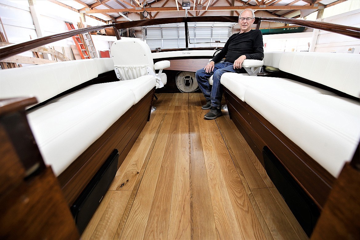 Syd Young sits in a 35-foot wooden boat in July he and his crew built at Dreamboats, Young's newest venture.