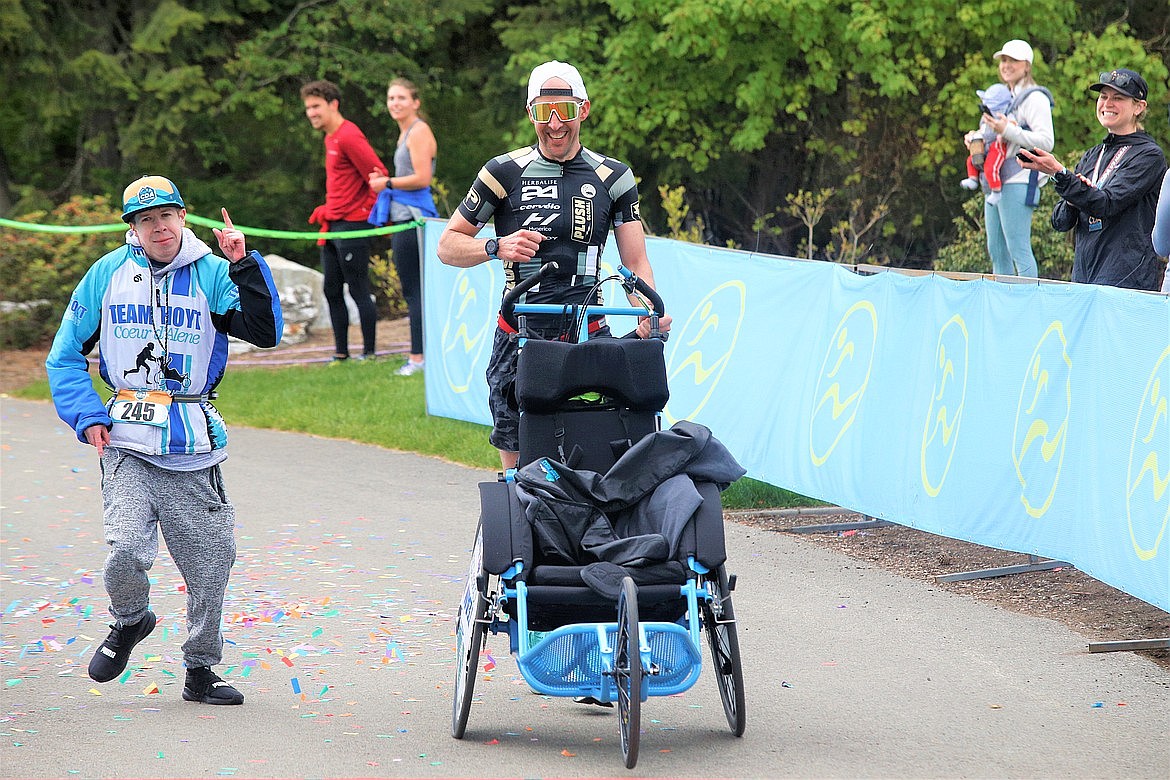 The Team Hoyt of Todd Curtis, right, and Anthony Eastman finish the Coeur d'Alene Marathon at McEuen Park in May.