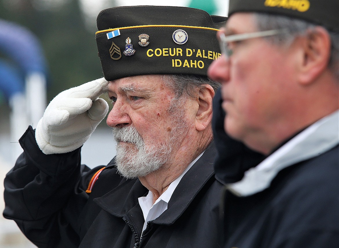 Veteran Bob Banta salutes after tossing the wreath in Lake Coeur d'Alene during the Memorial Day ceremony at Veterans Memorial Plaza.