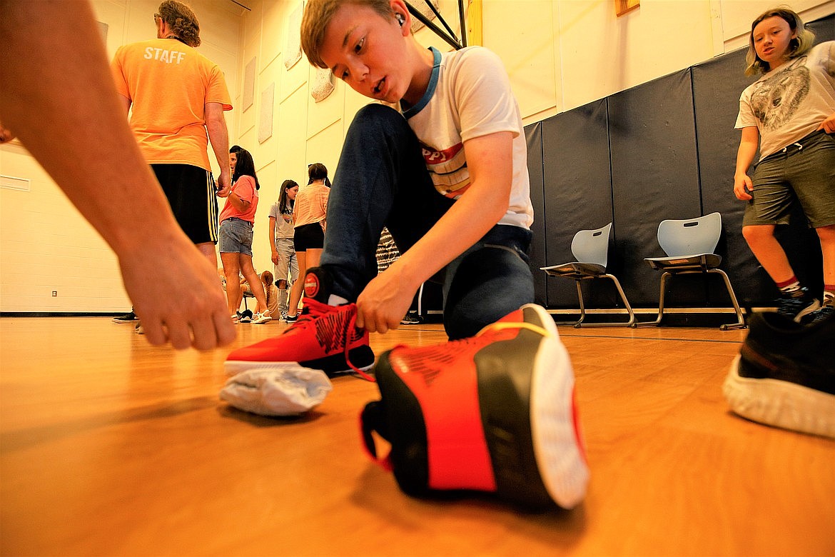 Hayden Novak tries on a shoe at the Lola and Duane Hagadone Boys and Girls Club of Kootenai County in July.