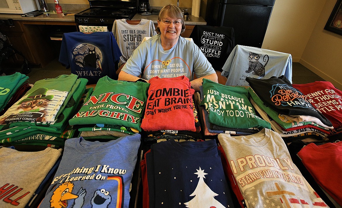 Lynn Tilley poses with some of T-shirt collection at Affinity at Coeur d'Alene in April.