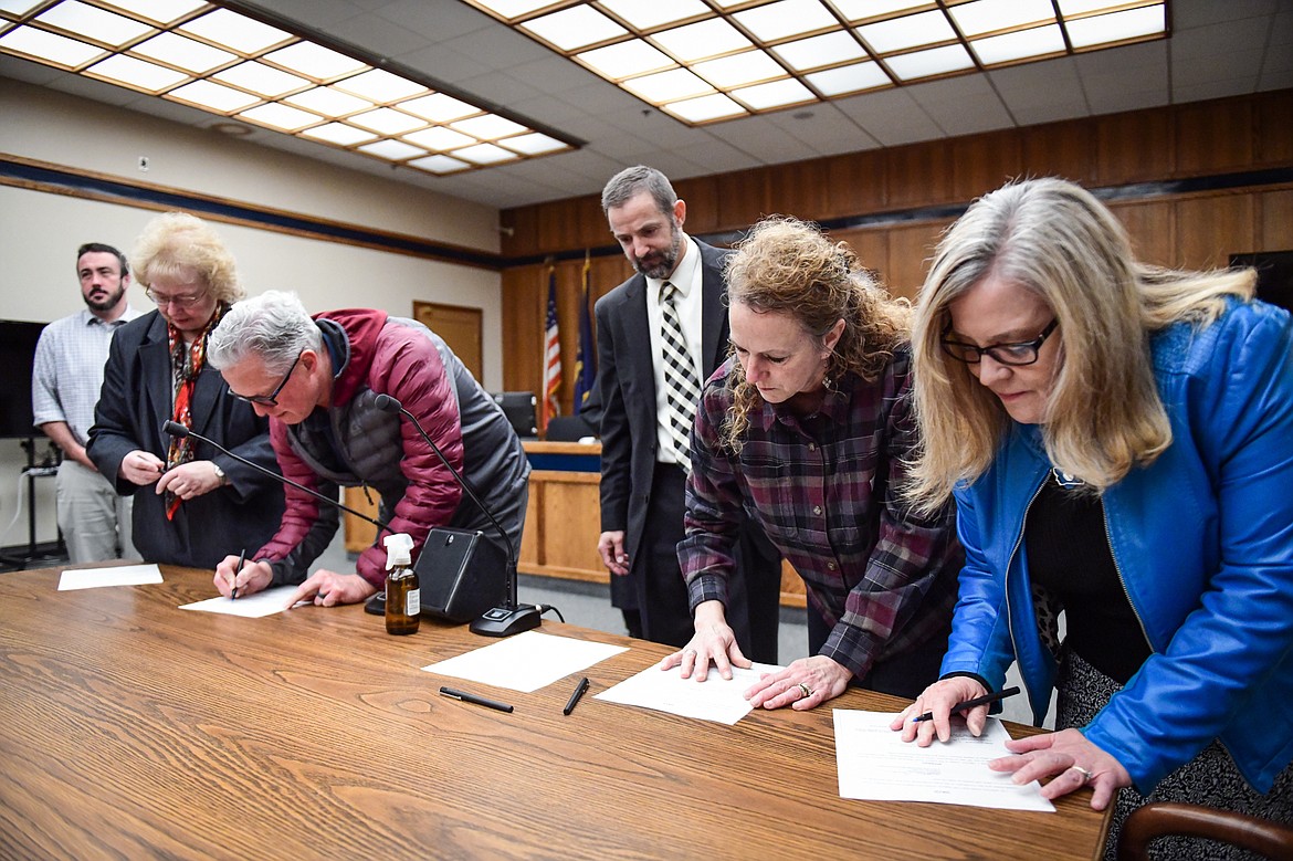 Flathead County elected officials are sworn in by District Court Judge Heidi Ulbricht during a ceremony at the Flathead County Justice Center on Thursday, Dec. 29. Being sworn in are, from left, county justice of the peace Paul Sullivan; county commissioner Pam Holmquist; county superintendent Cal Ketchum; county attorney Travis Ahner; county treasurer Adele Krantz; and county clerk and recorder Debbie Pierson. (Casey Kreider/Daily Inter Lake)