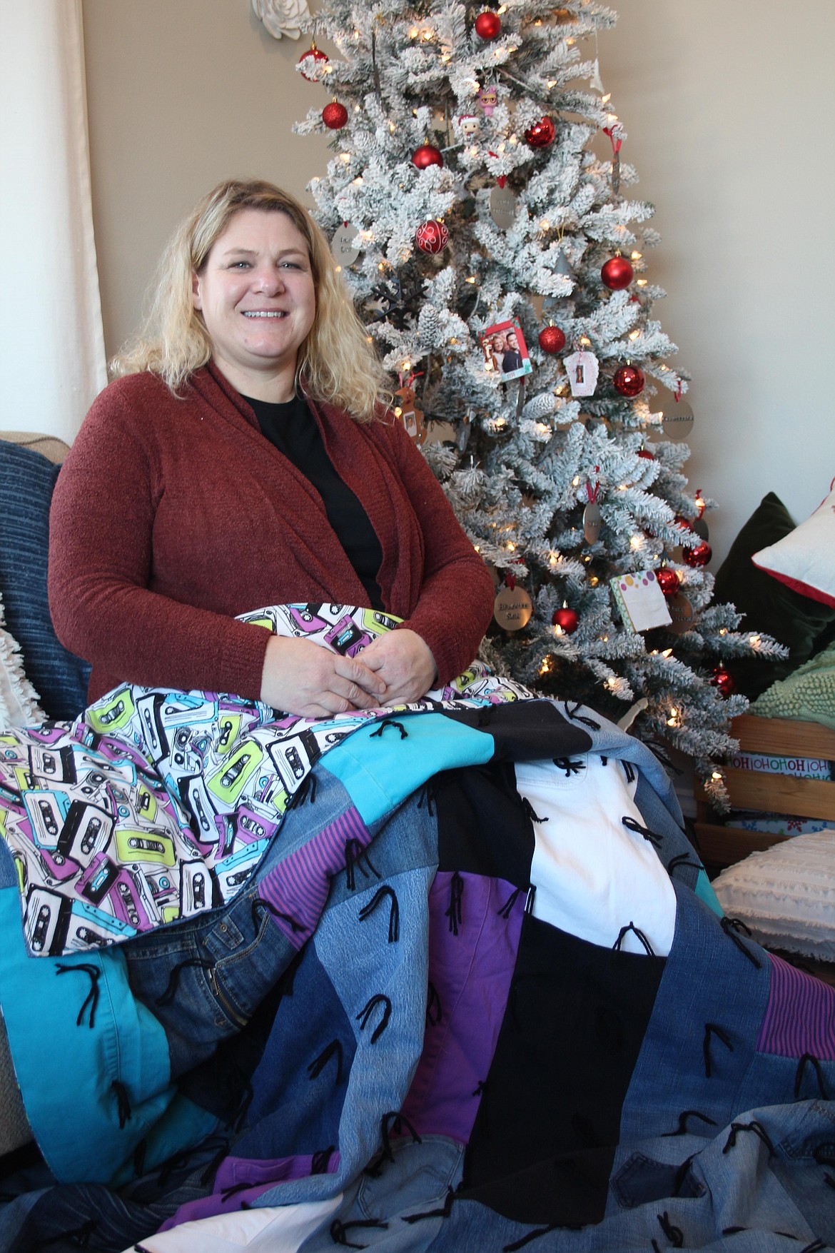 Keri Perez shows off one of the quilts she makes from old jeans.