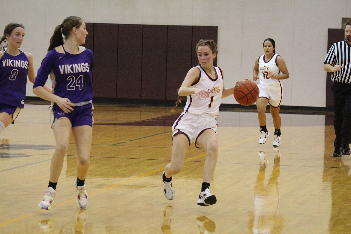 Sydney Macdonald (1) of Moses Lake brings the ball up the court against Addisyn Reffett (24) of Lake Stevens Thursday in the Mavericks’ second game of the Lady Mavericks Christmas Mixer at Moses Lake High School. Lake Stevens defeated Moses Lake 49-29.