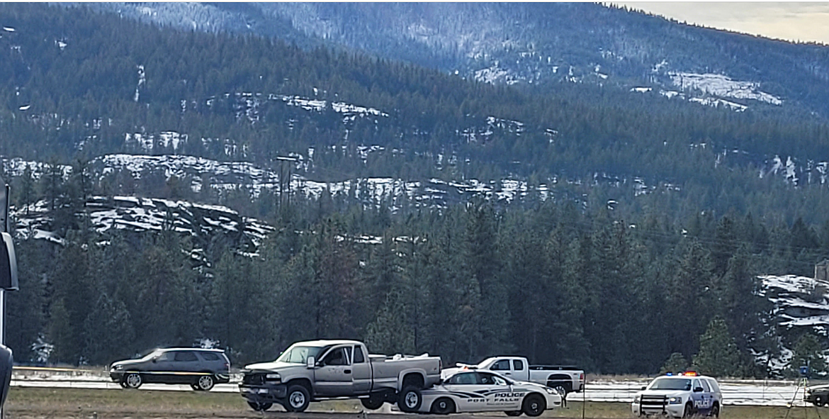 A truck rests on top of a Post Falls Police cruiser on the north side of Interstate 90 after a suspect pursuit Thursday morning in Post Falls.