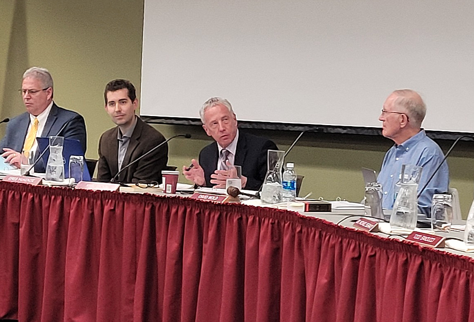 Former North Idaho College attorney Marc Lyons, center, gestures as he discusses forgone taxes during a board of trustees meeting May 25.