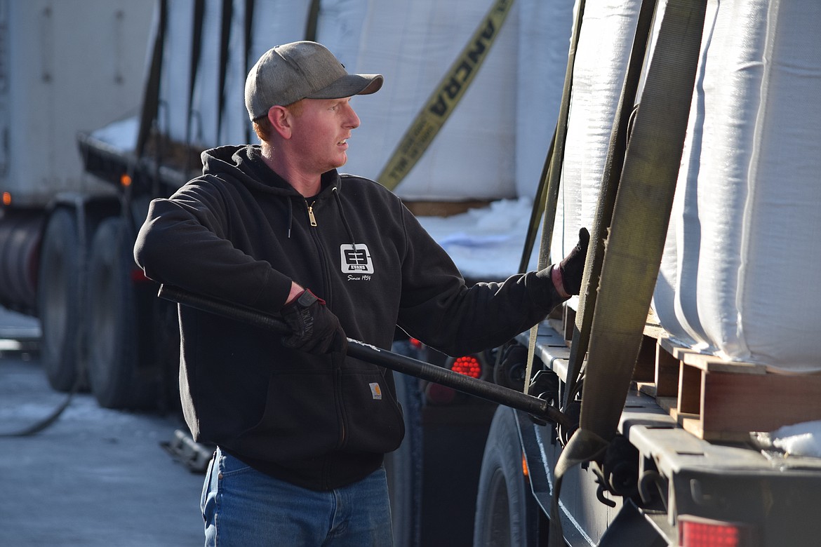 Truck driver Theron Wood checks to see that the 32-ton load of palm fat he is hauling from Tacoma to Caldwell, Idaho, is properly secured to his truck.