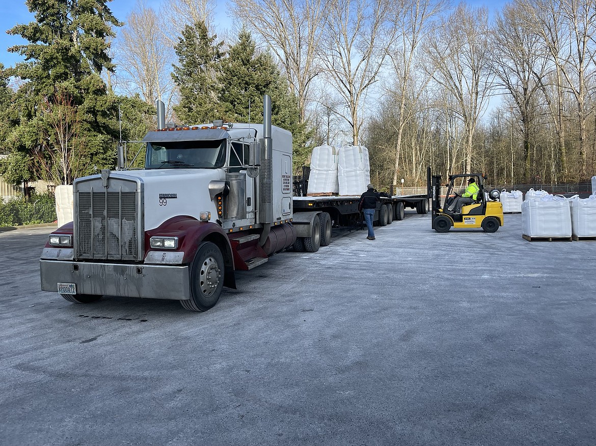 Theron Wood’s big rig being loaded with 32 one-ton totes of Malaysian palm fat in the parking lot of Global Agri Trade in Fife, Washington. Wood will haul the palm fat to Caldwell, Idaho, where it will be used as an ingredient in livestock feed.