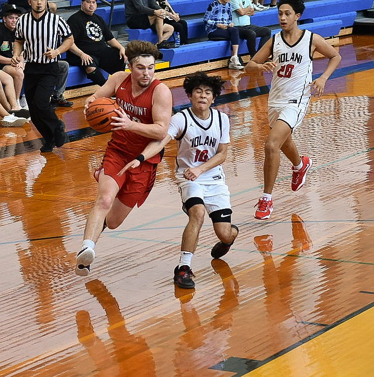 Arie VanDenBerg pushes forward for a shot in Friday nights game against Iolani.