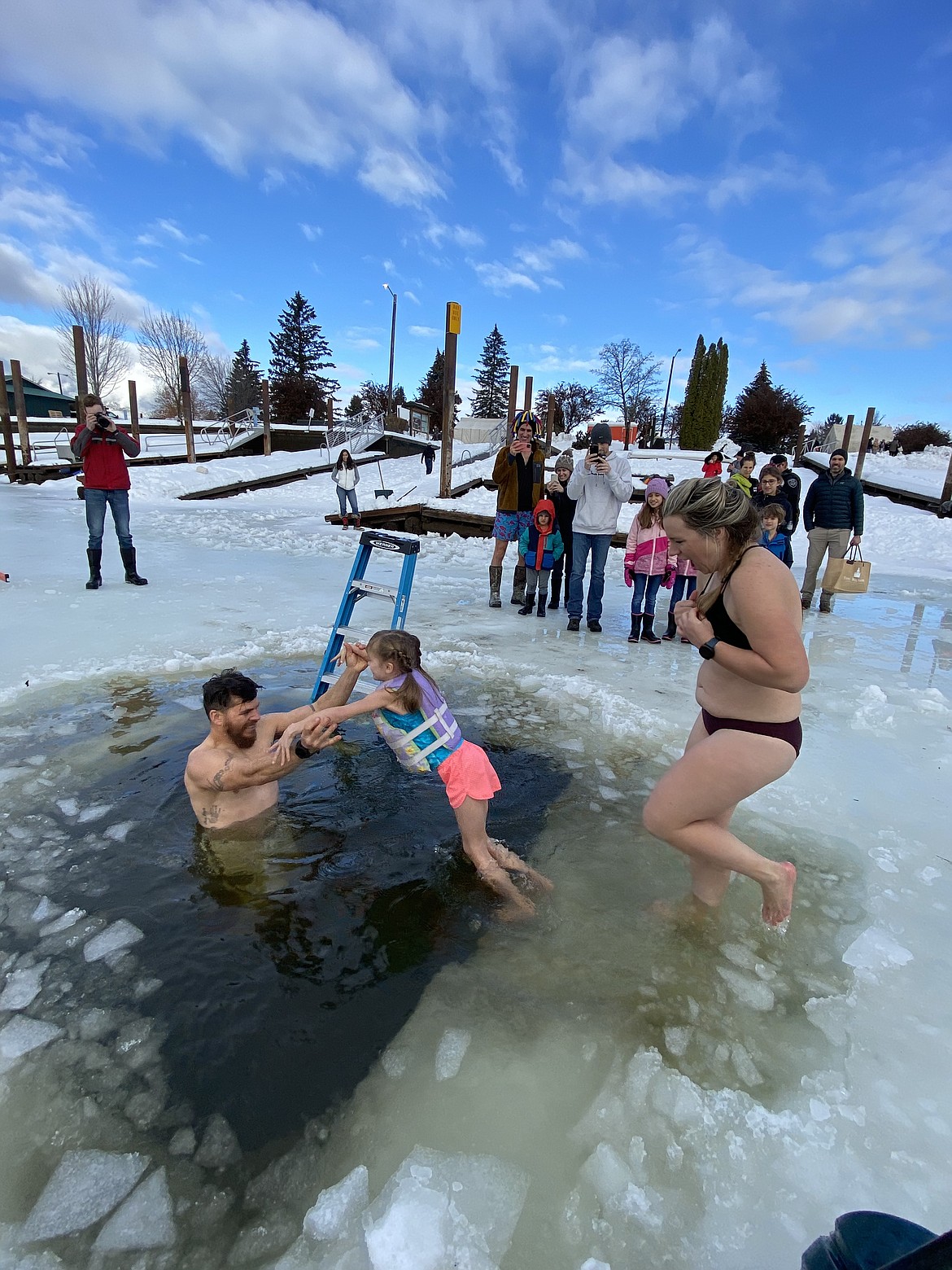A family takes part in the annual Polar Bear Plunge on Sunday. The event is a collaboration by Boy Scout Troop 111 and the city of Sandpoint.