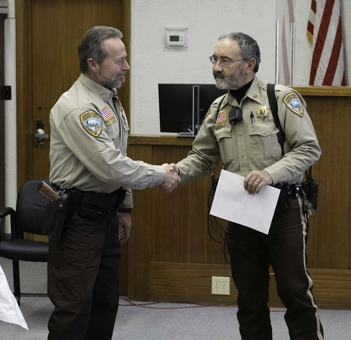 Retiring Sanders County Sheriff Tom Rummel congratulates incoming Sheriff Shawn Fielders. (Tracy Scott/Valley Press)
