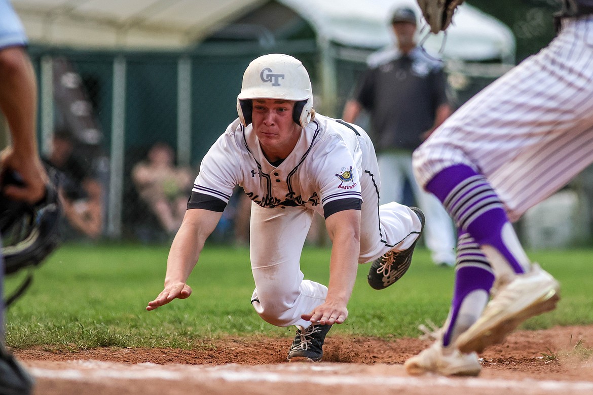 Jacob McIntyre slides into home plate at Memorial Field. (JP Edge photo)