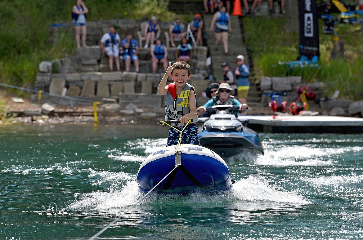 Eight-year-old Robert Otanez takes a ride on an inflatable water ski during DREAM Adaptive's week-long annual Water Sports Program at Echo Lake. (Whitney England/Whitefish Pilot)