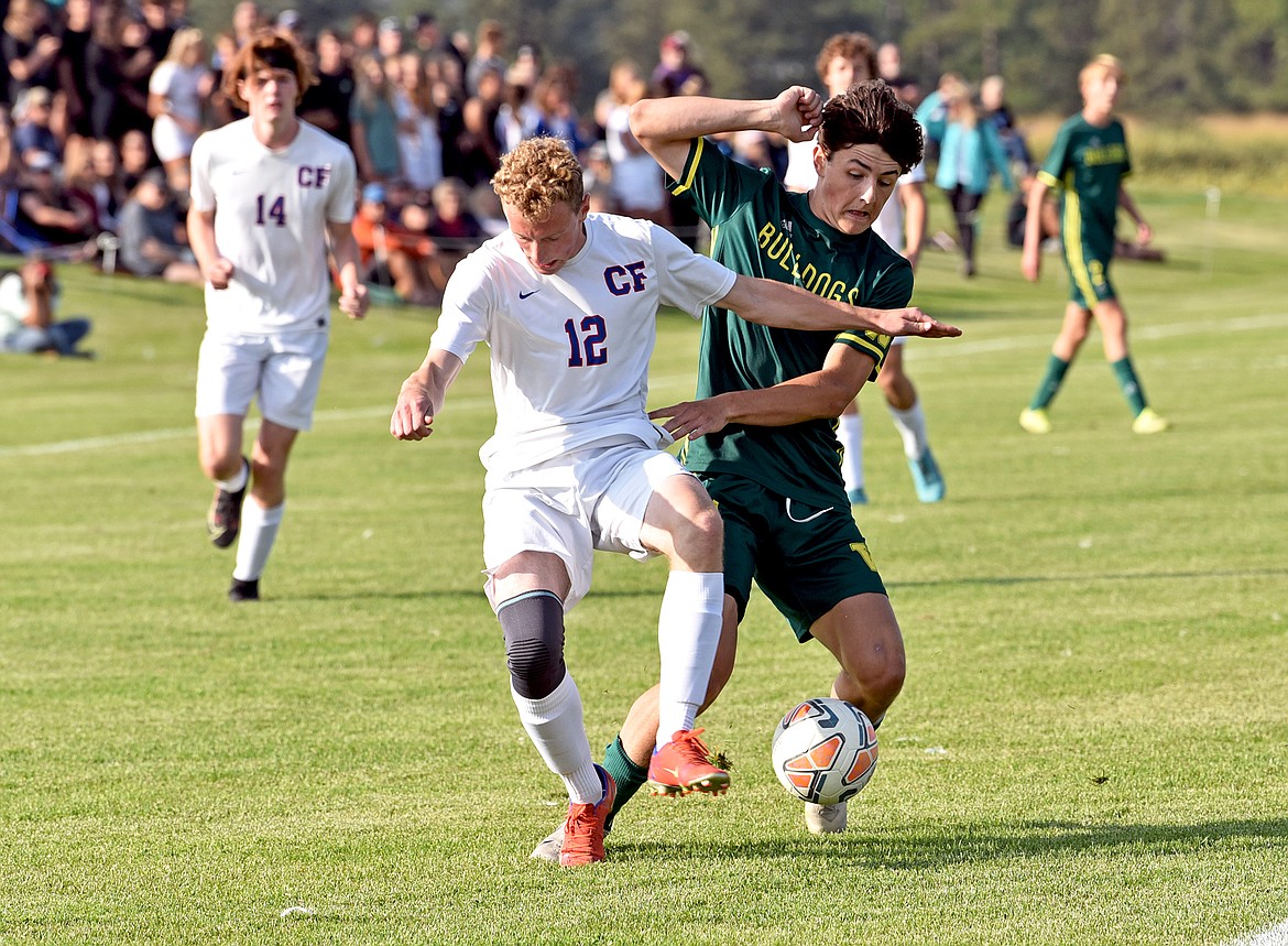 Bulldog Collin Lyman attempts to get around Wildcat defender Andrew Miner. (Whitney England/Whitefish Pilot)