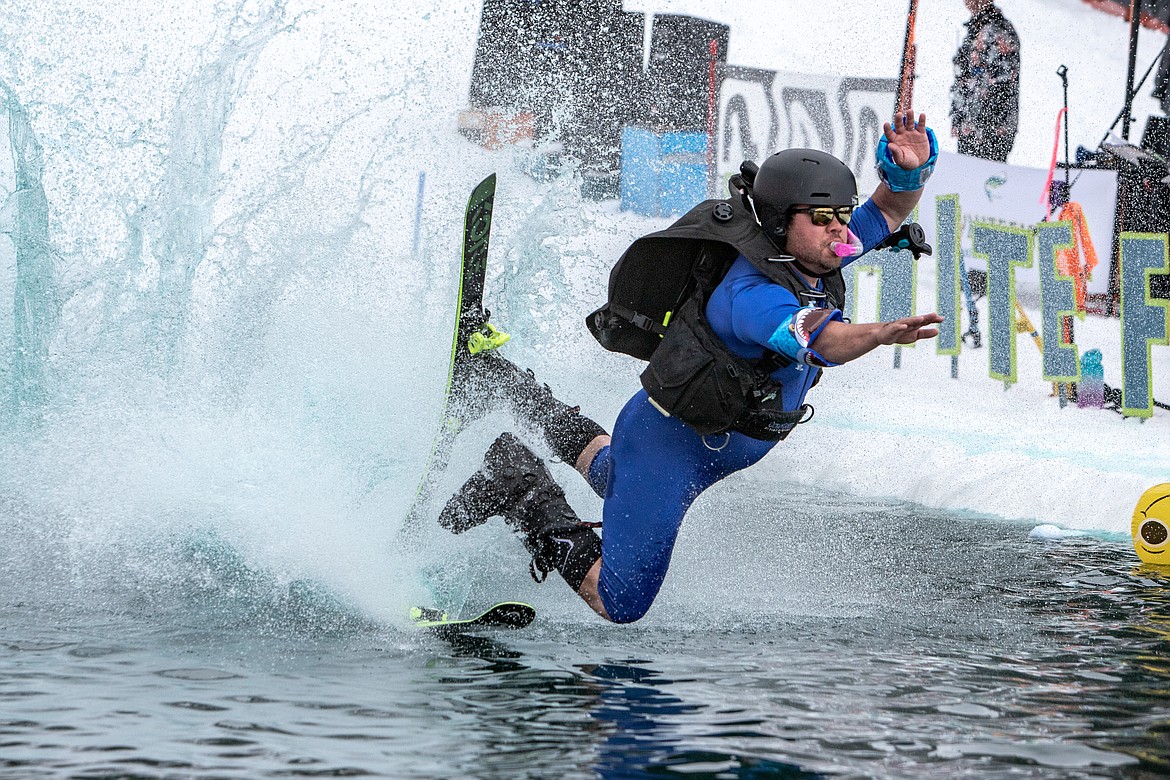 A scuba diver takes a swim in the cold water during the pond skim. (JP Edge photo)