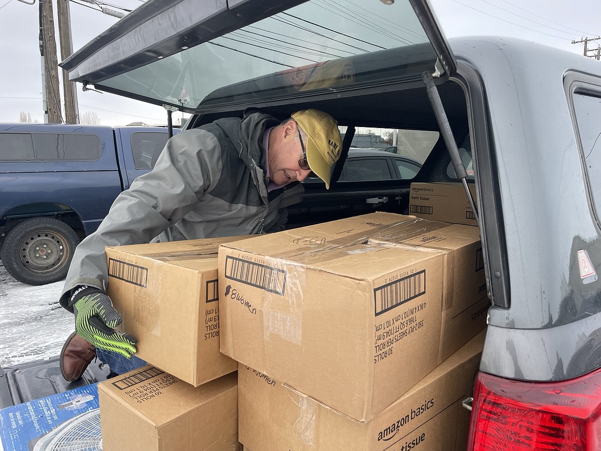 Dennis Draleau, communications director for the Church of Jesus Christ of Latter-day Saints Moses Lake Stake, unloads boxes of hygiene kits – complete with toilet paper, wash cloths, soap, toothpaste, toothbrushes and other essential toiletries – behind Serve Moses Lake on Tuesday. Church volunteers got together on Dec. 28 and put 400 of the kits together – 200 for Serve Moses Lake, and 100 each for HopeSource and New Hope.