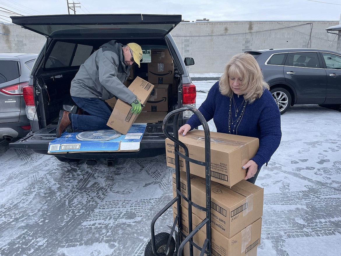 Dennis Draleau, communications director for the Church of Jesus Christ of Latter-day Saints, and Serve Moses Lake volunteer Sheryl Ulnick unload boxes full of hygiene kits – 200 in all – that Serve Moses Lake will distribute to the area’s homeless.