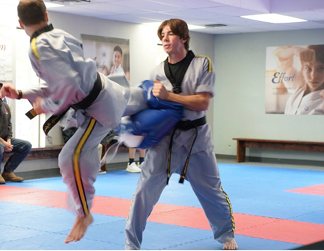 Sandpoint Martial Art students, Mr. Edward and Mr. Joe performing kicks for a degree testing.