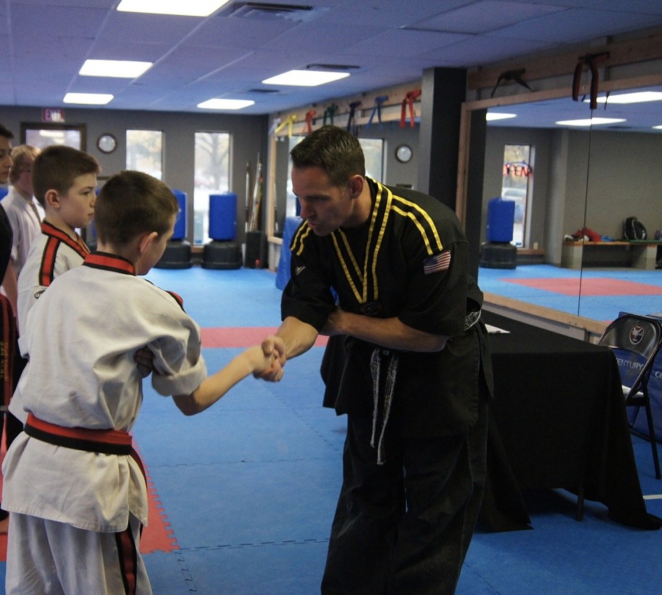 Mike Szotkowski (or Mr. S. as the kids call him) awarding Josh his belt at end of testing.