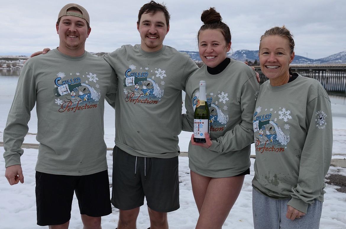 Polar Plungers Chandler Paulson, Scott Twite, Tessa Burke and Joy Twite model this year's t-shirts. According to Joy, the New Year's Day dunk helps "wash off the past year." (Kristi Niemeyer/Lake County Leader)