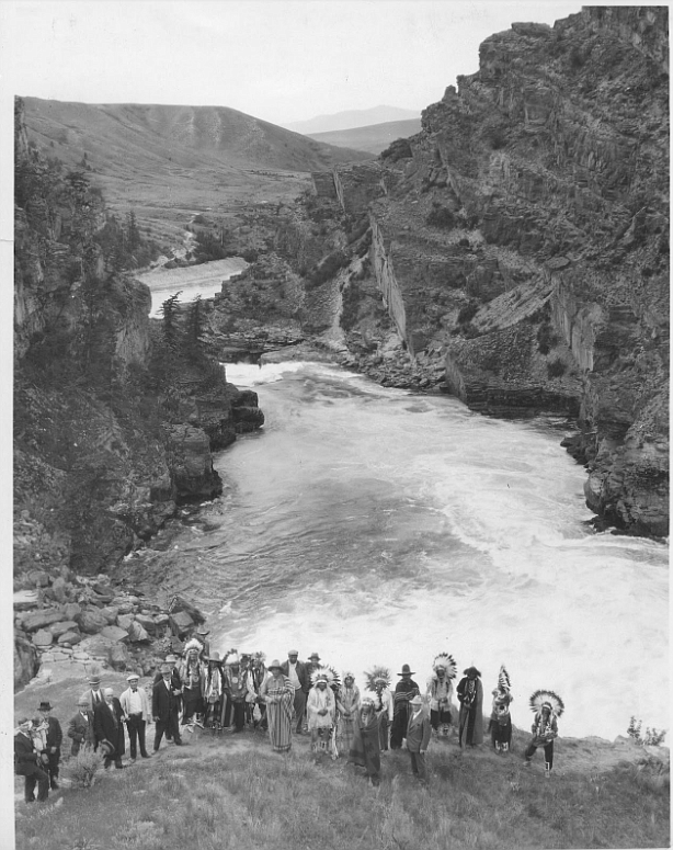 Representatives from multiple parties gather to dedicate the start of construction at the current day site of the Seli’š Ksanka Qlispe’ Dam south of Polson. Chief Koostahtah is in the center in white. (Credit – Denny Kellogg Collection)