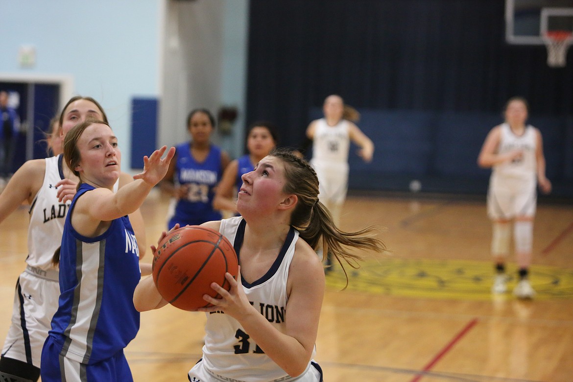 MLCA/CCS senior Makiya Kast, right, looks up at the basket during a Dec. 6 game against Manson. Against Lummi Nation on Friday, Kast converted on seven of 11 three-point attempts.