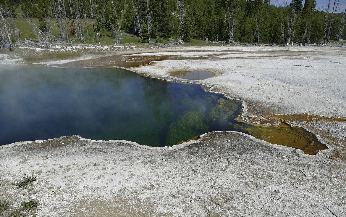 This photo provided by the National Park Service shows the Abyss Pool hot spring in the southern part of Yellowstone National Park, Wyo., in June 2015. Investigators found a laptop computer, notebooks and a book of poems with handwriting in it but no suicide note in the car of a man whose partial foot was found floating in a shoe in the Yellowstone hot pool, according to National Park Service documents released Tuesday, Jan. 3, 2023. The law enforcement investigation documents posted online offered new details but no solid clues to how the foot of Il Hun Ro, 70, of Los Angeles, got in the Abyss Pool last summer. (Diane Renkin/National Park Service via AP, File)