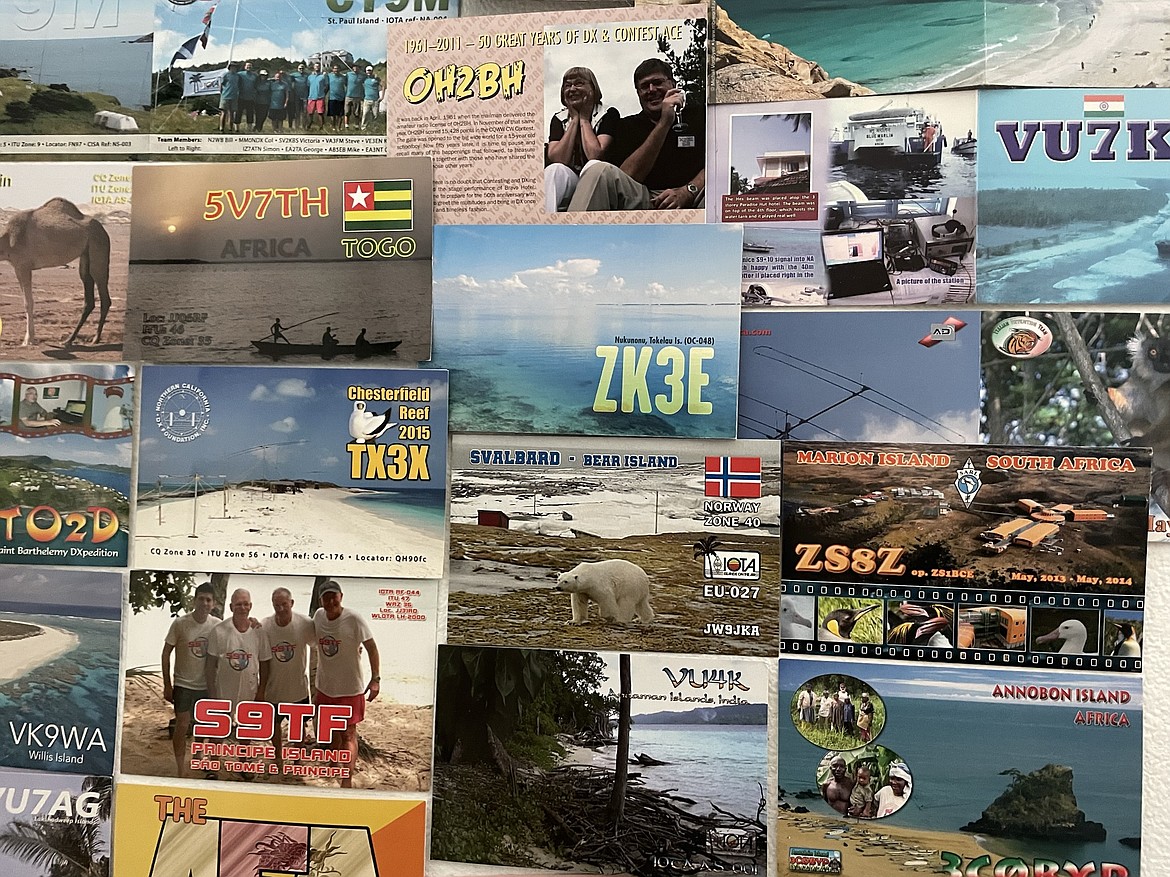 A collection of QSL cards — responses to the question “Can you hear me?” — tacked up inside Brian and Leigh Ann Nielson’s radio shack from radio amateurs across the world.