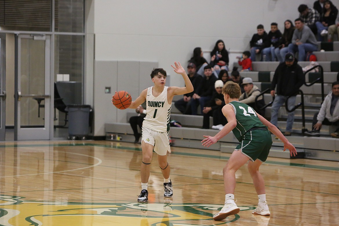 Quincy freshman Pierce Bierlink takes the ball up the floor while calling out a play to his teammates. Bierlink finished Tuesday’s 83-81 win over Chelan with 24 points.