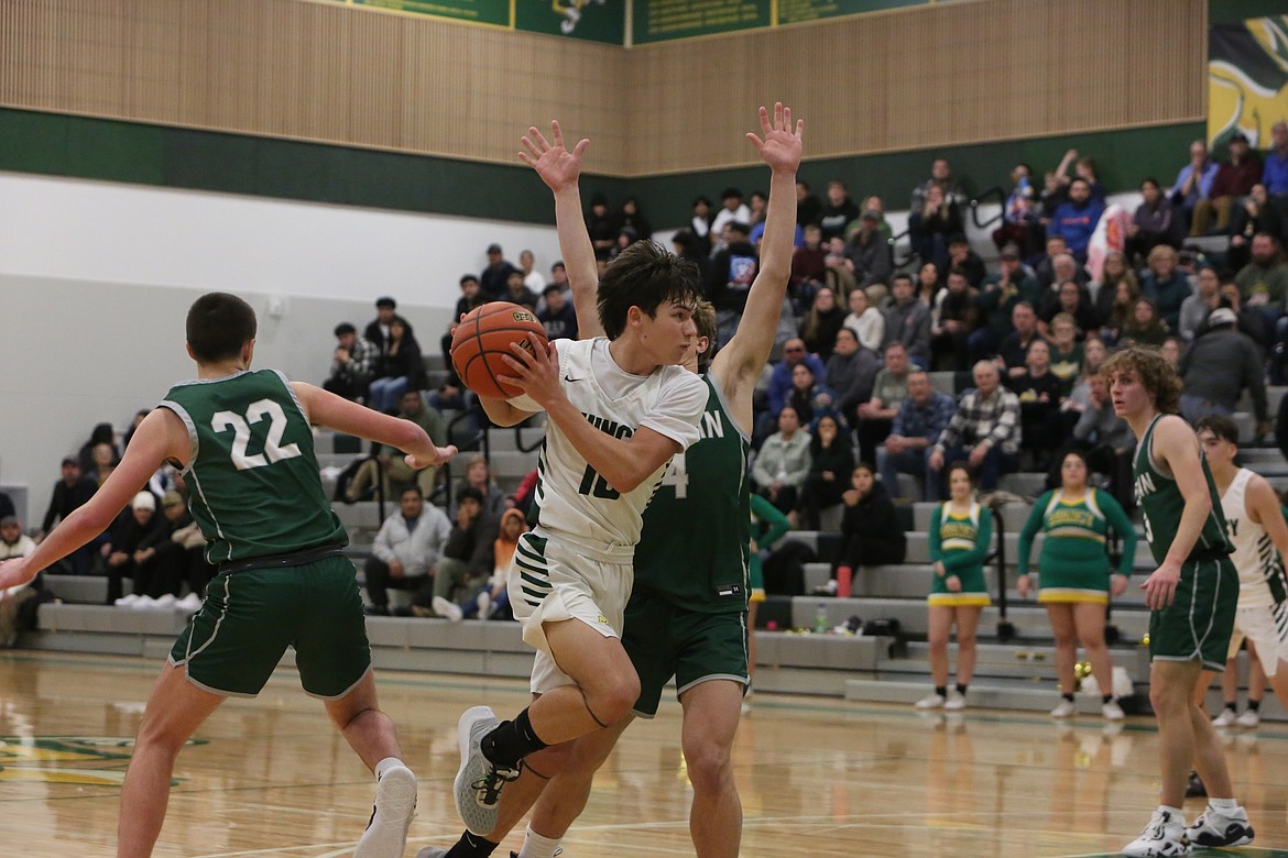 Quincy’s Ethan Gregg blows past a Chelan defender late in the fourth quarter in the Jackrabbit’s 83-81 win over the Goats.