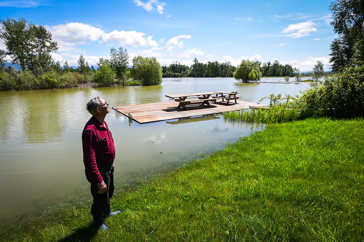 Verdell Jackson stands in the backyard of his residence along Wagner Lane as floodwaters from the Flathead River rise up around his deck on Tuesday, June 21. (Casey Kreider/Daily Inter Lake)