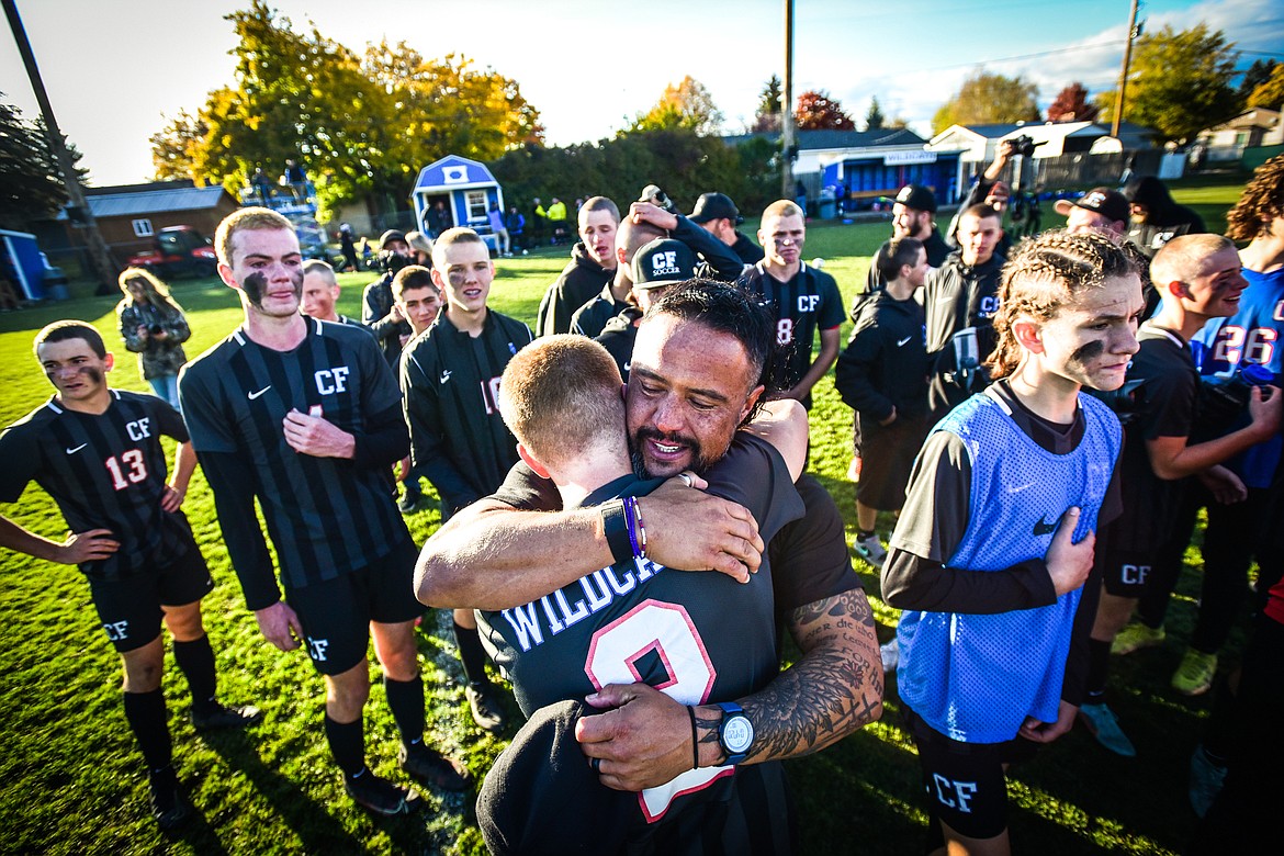 Columbia Falls head coach O'Brien Byrd hugs senior midfielder Walt Nichols (2) after the Wildcats 5-2 win over Livingston in the State A championship at Flip Darling Memorial Field in Columbia Falls on Saturday, Oct. 29. (Casey Kreider/Daily Inter Lake)