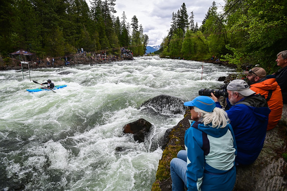 Spectators watch as a kayaker navigates a section of the Wild Mile along the Swan River during the Expert Slalom event at the 47th annual Bigfork Whitewater Festival on Saturday, May 28. (Casey Kreider/Daily Inter Lake)